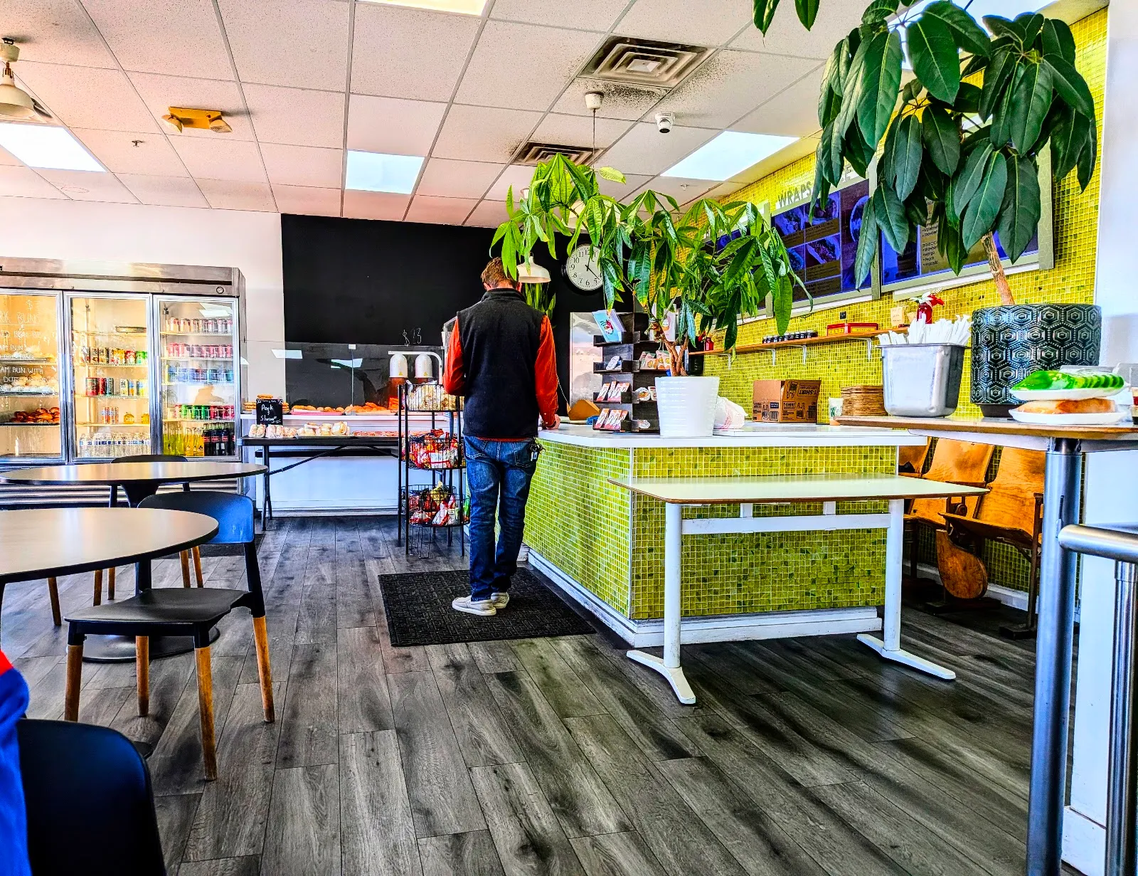 Interior with the pastry case and yellow-tiled counter